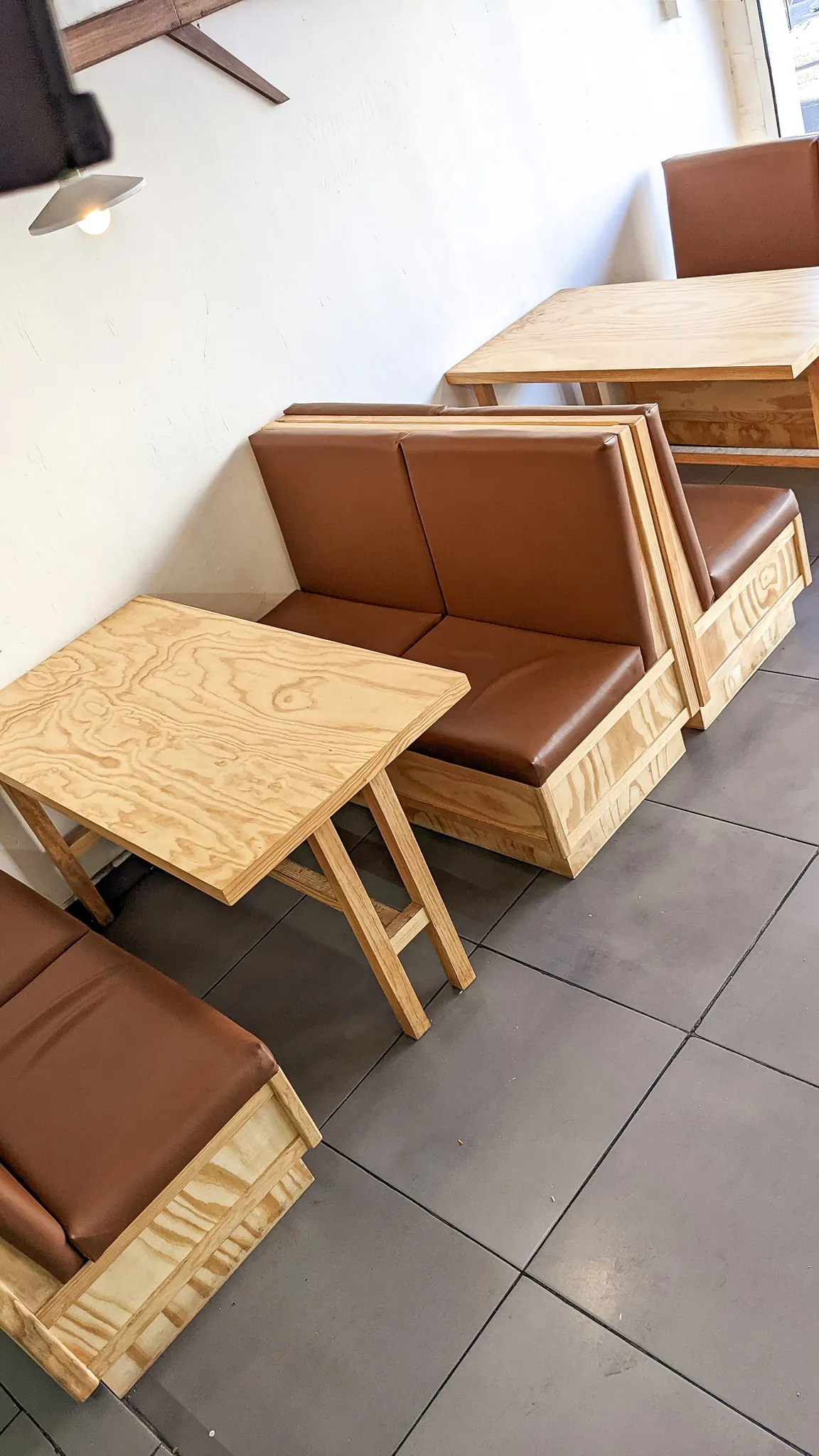 Square close-up of booth seating with brown leather upholstery