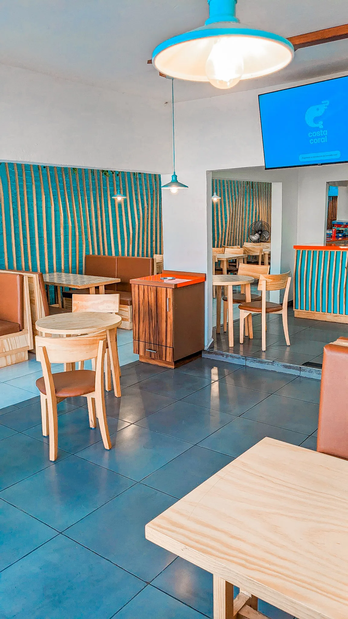 Square wide angle view of the dining space with turquoise walls
